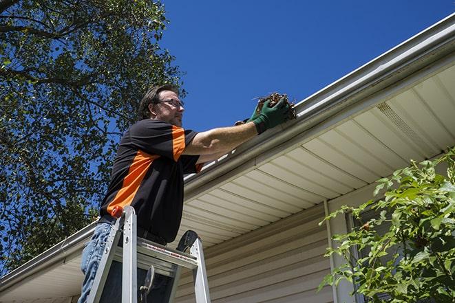 gutter being fixed by a maintenance person in Landers, CA